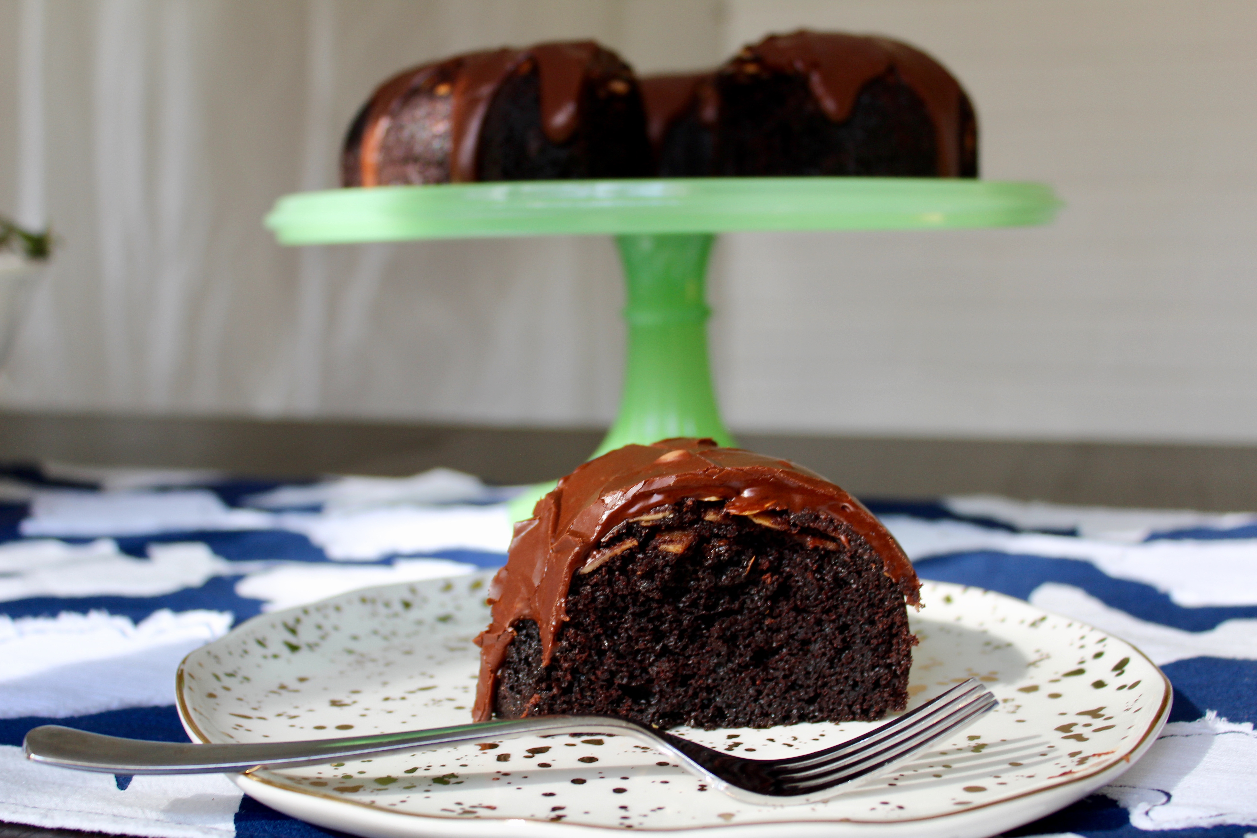 Slice in and find a hidden layer of toasted almonds nestled between the chocolate glaze and rich, moist cake.